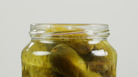 hand placing lid on a jar of pickles