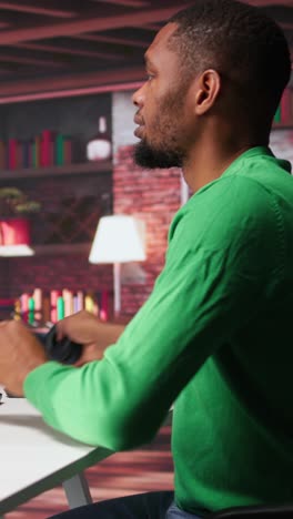 vertical video black guy using text to image ai chat software at his modern loft
