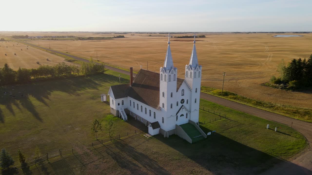 Aerial footage of St Peters roman catholic church in prairie during sunset