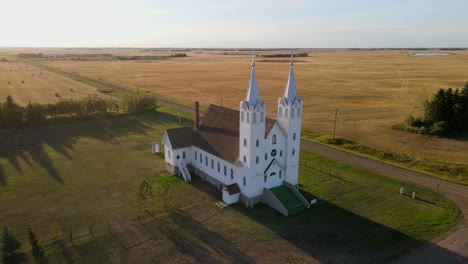 aerial footage of st peters roman catholic church in prairie during sunset