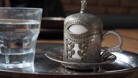 traditional turkish coffee pot with a cup of water