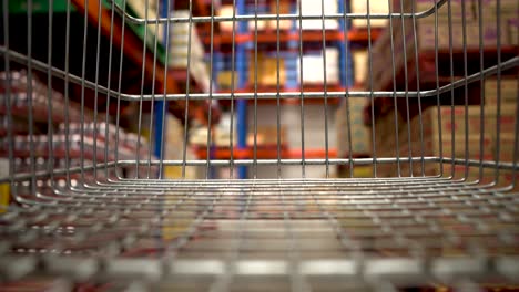 looking for toilet paper with empty shelves due to coronavirus - point of view from the shopping cart