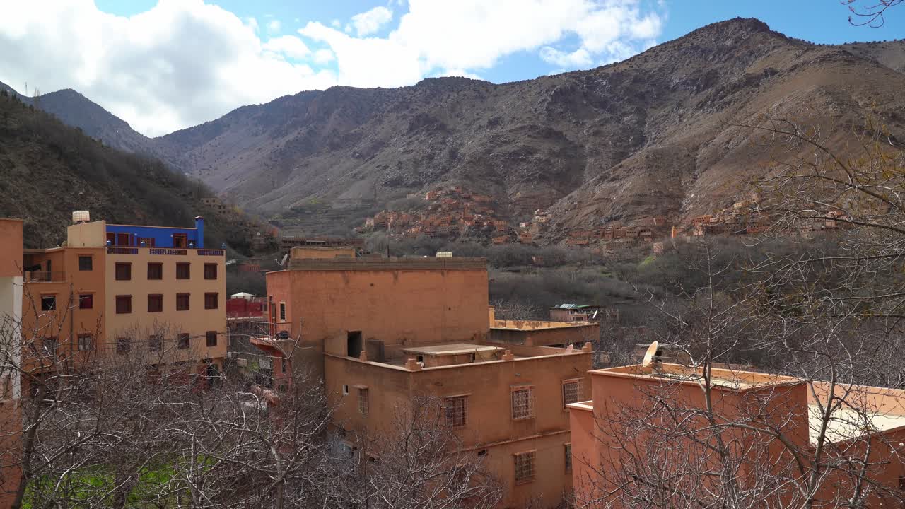 Vibrant greenery blankets the hills around Imlil Village, contrasting beautifully with the rocky peaks of Toubkal Mountain towering in the distance