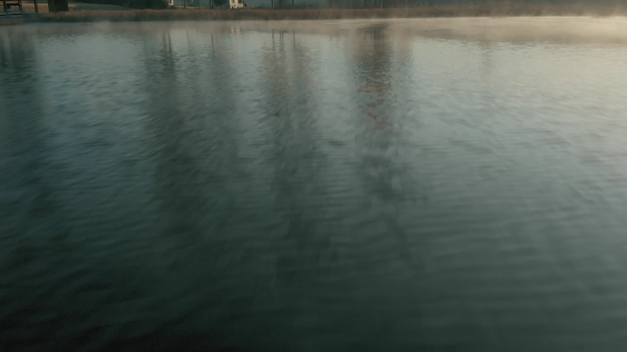 Drone flying fast over lake water