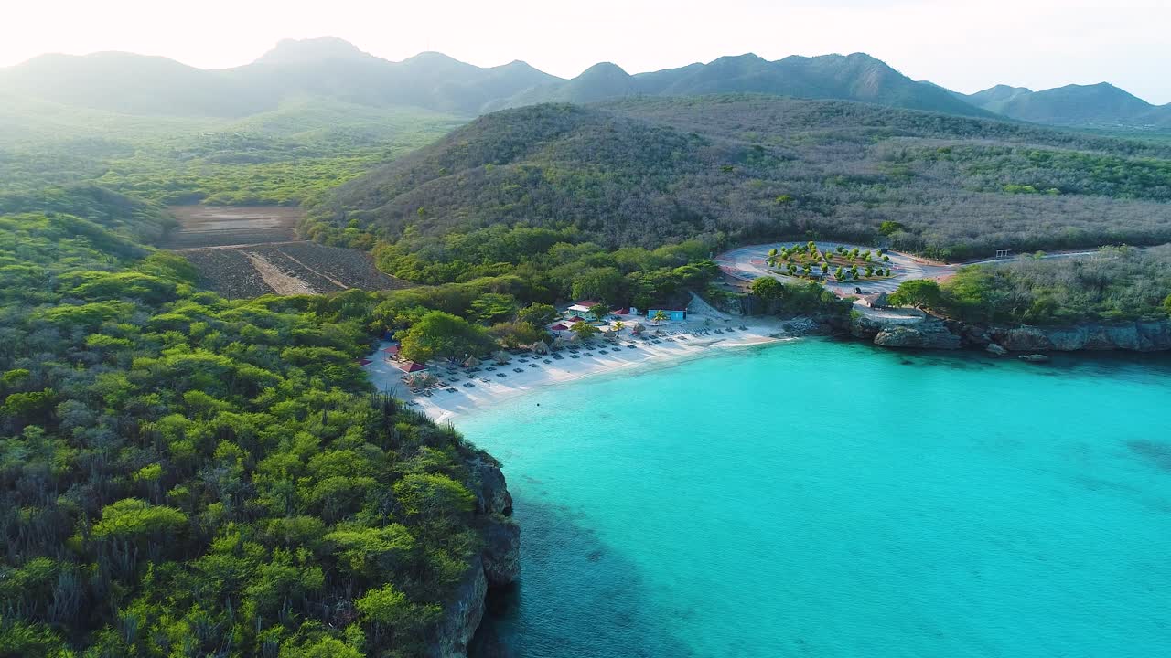 Aerial high angle establish overview above Grote Knip beach Curacao, view from ocean to land