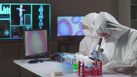 asian team of scientists is working on a vaccine in a modern scientific research laboratory. genetic engineer workplace. future technology and science concept