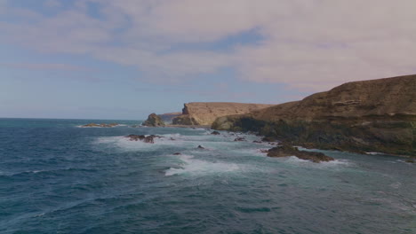 breathtaking views of fuerteventura with lobos island, red flag beach, kite surfers, sunsets, volcanoes, sand dunes, and wingfoilers in the canary islands’ golden light.