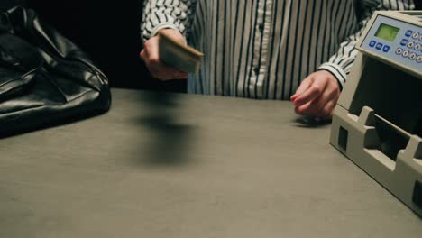 specialised police officer counting dollar banknotes in crime lab, conceptual image. high quality 4k footage