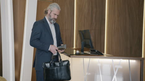 businessman checking in at hotel reception