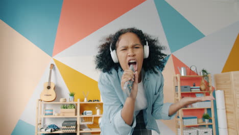 teenage girl singing karaoke at home