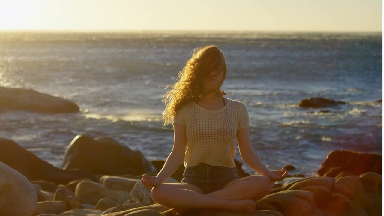 Young Woman Practicing Yoga and Exploring Coastal Landscape