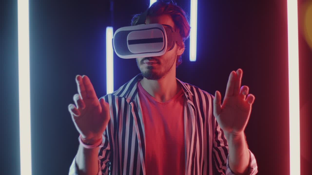 Man wearing VR headset, experiencing virtual reality in neon light