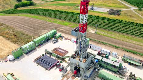 Aerial-View-Of-Oil-Drilling-Rig-On-Field---drone-shot