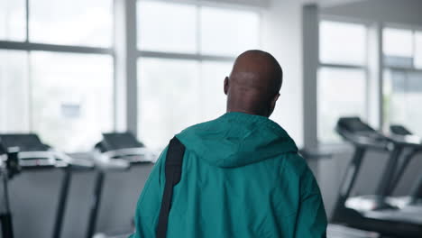 man in gym with treadmills