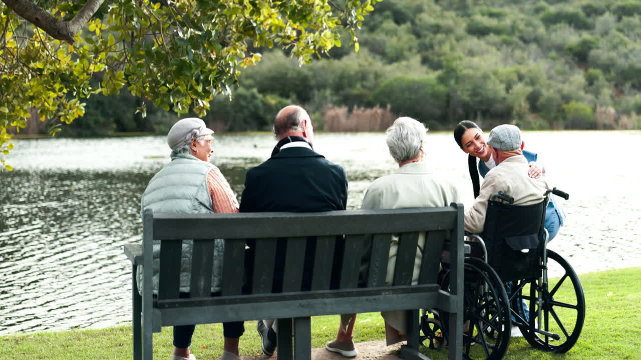 Elderly people with caregiver in a park