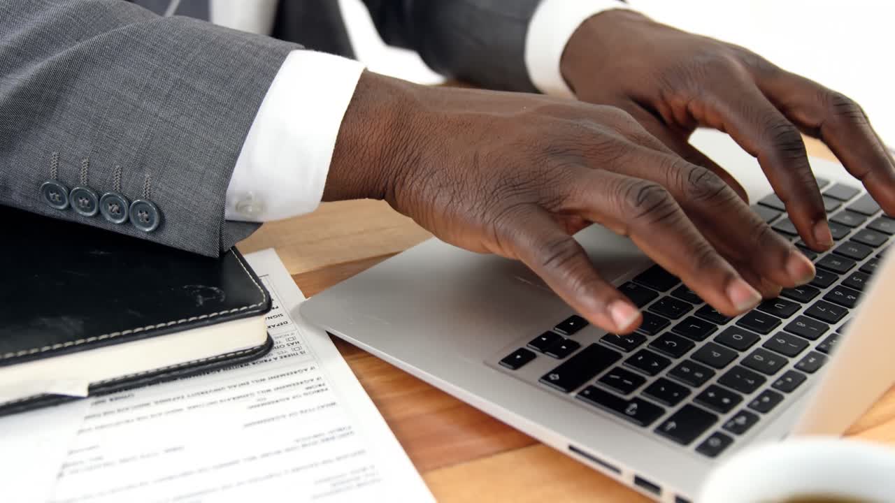 Businessman using laptop at his desk