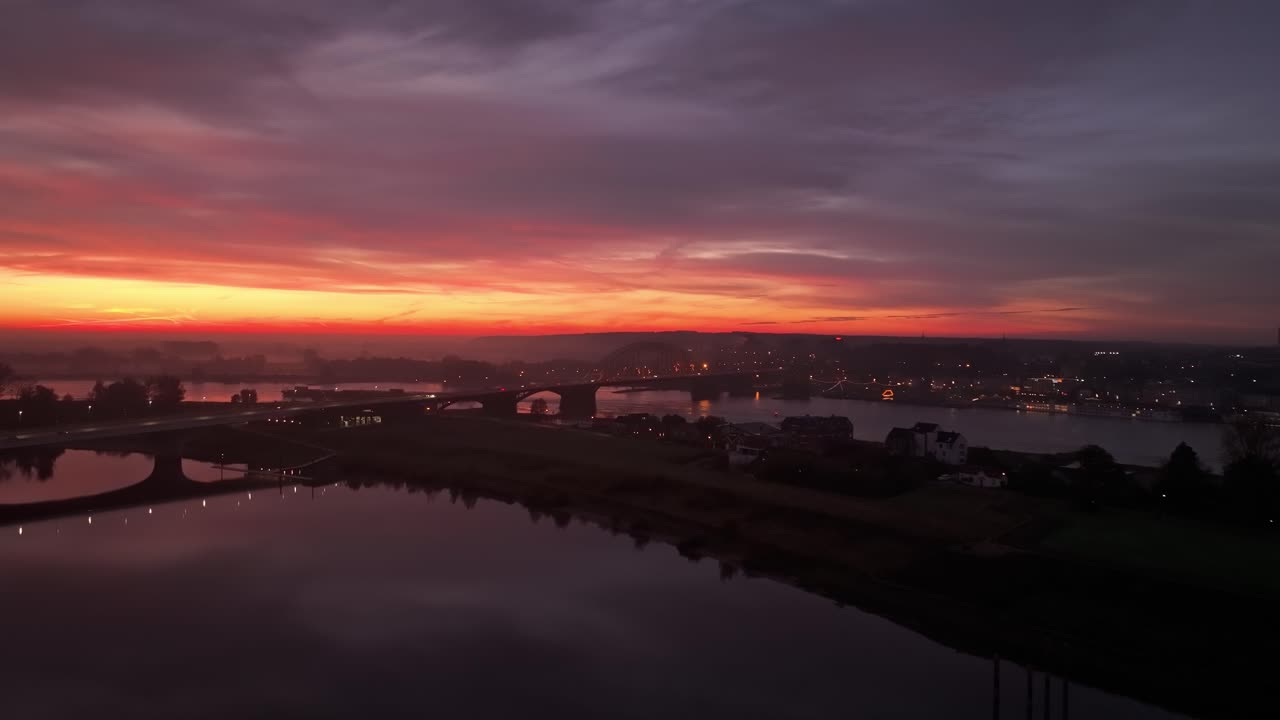 Waalbrug spanning the Waal River at vibrant sunrise