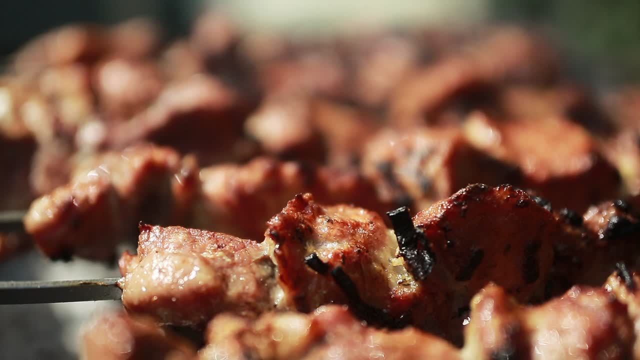 Grilling Shashlik On Barbecue Grill. Marinated shashlik preparing on a barbecue grill over charcoal