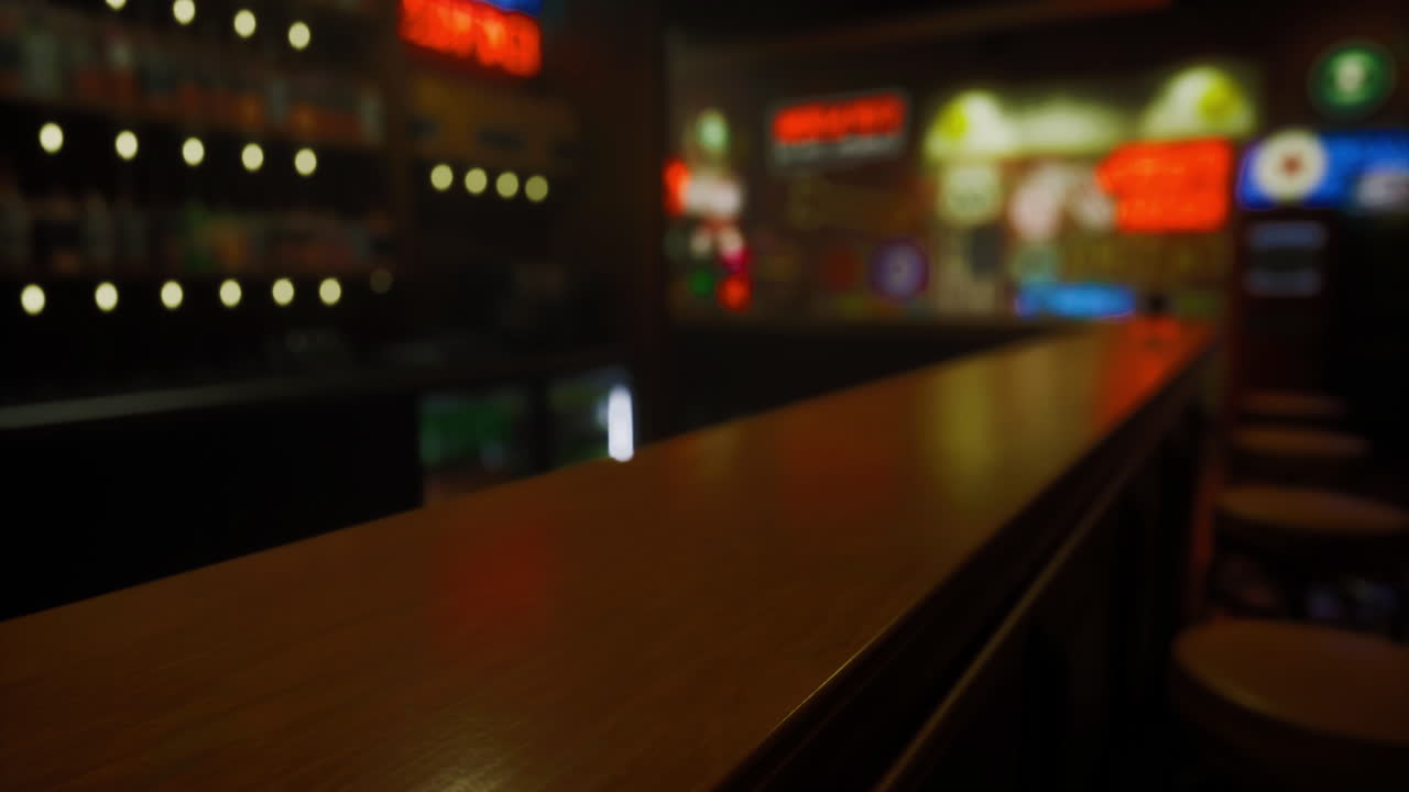 Cozy bar interior with illuminated signs and wooden counter at night