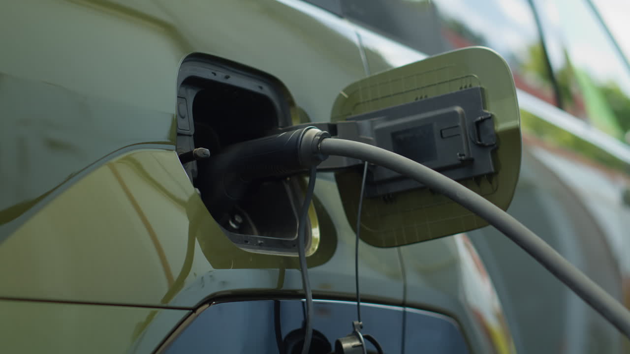 Close Up Shot Of Electric Vehicle Charging At Modern Station