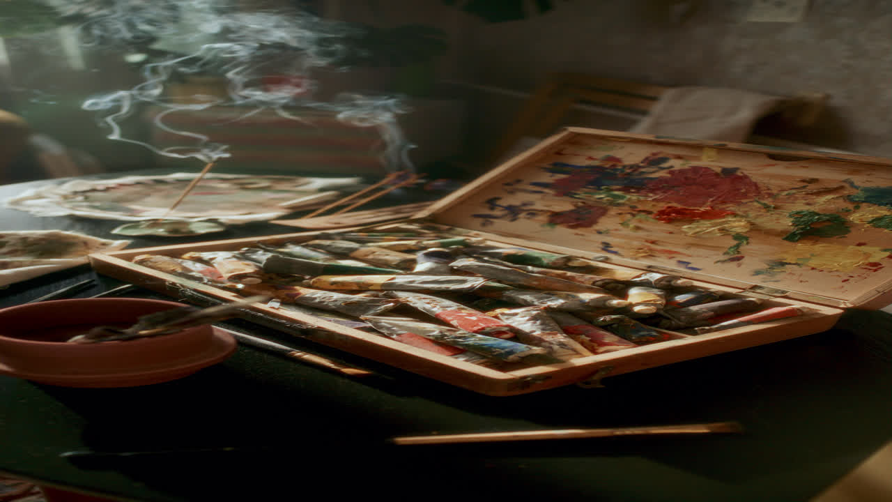 Open Wooden Box with Paint Tubes and Brushes in Home Studio