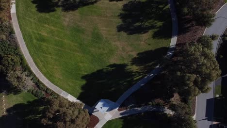 birds eye view rising above landscaped park with footpath around lawn area