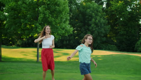 family playing with ball in summer park. positive parents throwing ball in air