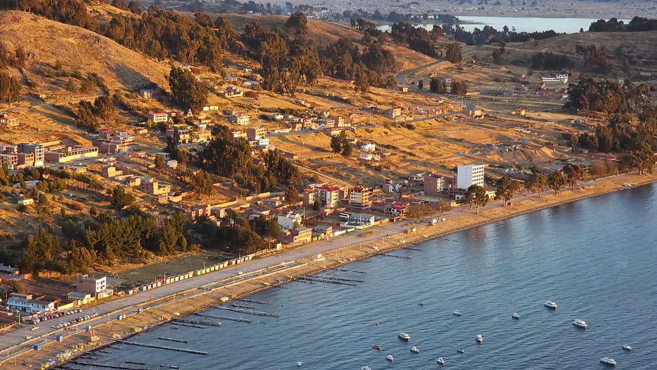 Experience a breathtaking aerial view of Copacabana Harbor in Bolivia, as dusk settles over Lake Titicaca