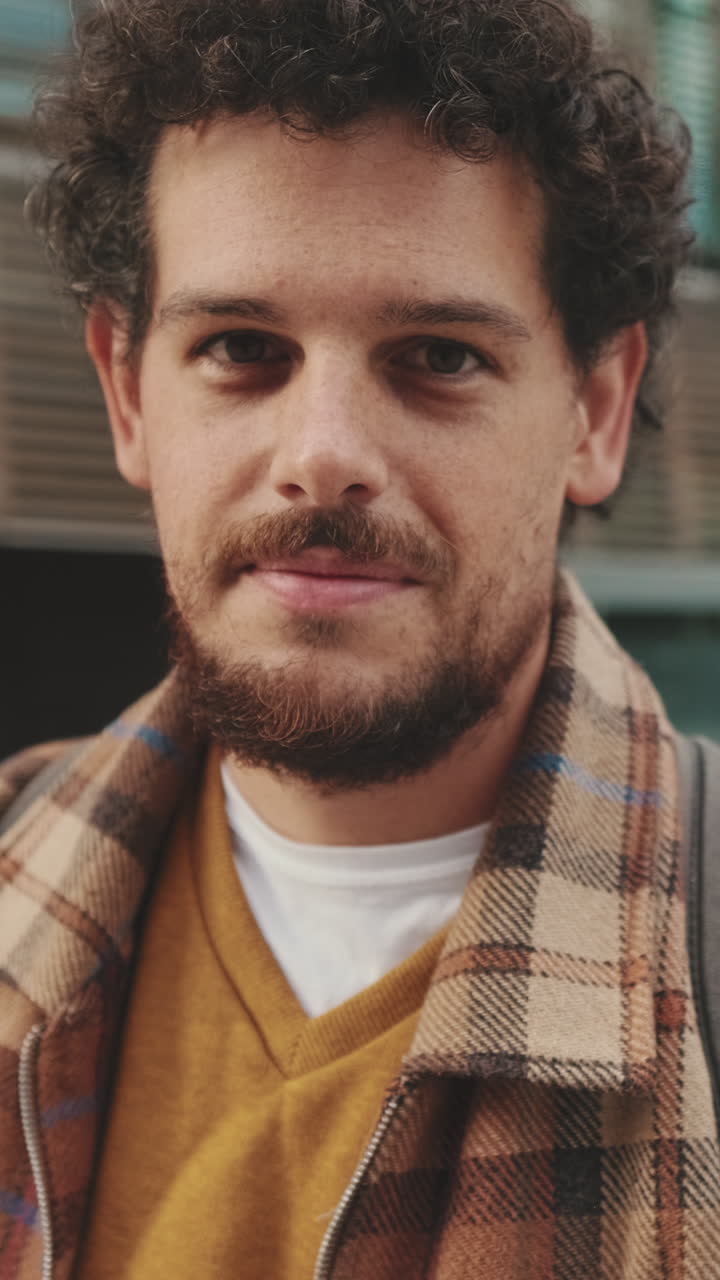 Portrait of a man with curly hair and a beard