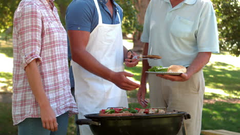 happy man doing barbecue for his family