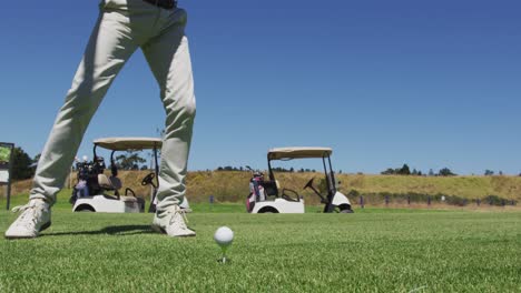 caucasian senior man practicing golf at golf course on a bright sunny day