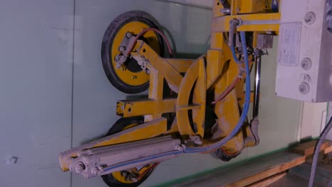 glass handling machine lifting a sheet of glass