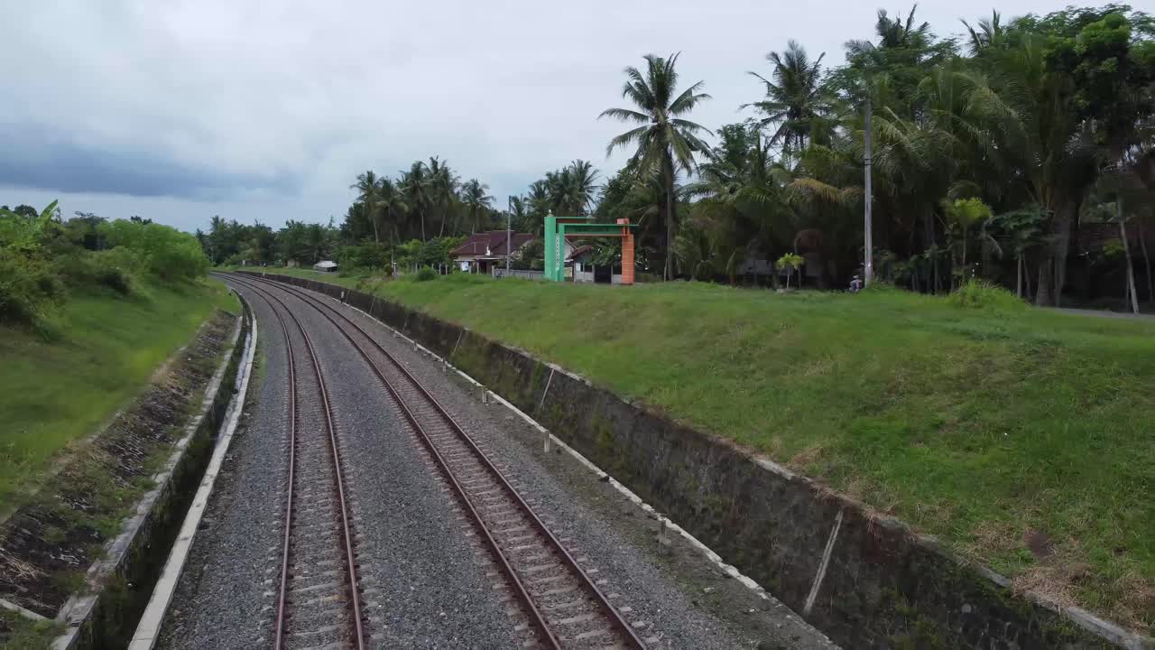 Train journey point of view from driver's view. Indonesian railway track