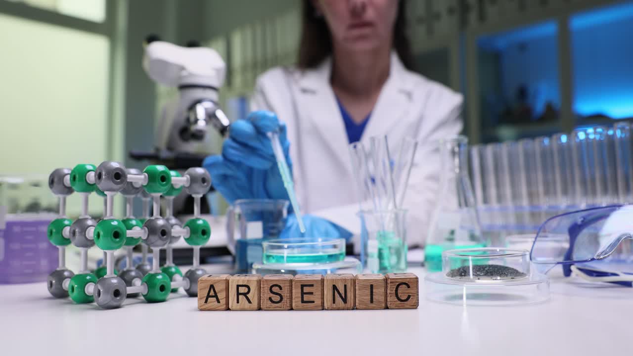 A scientist conducting research with arsenic in a laboratory