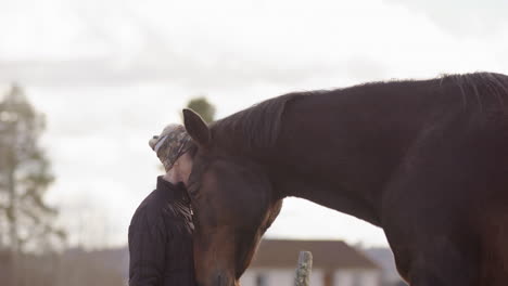 Powerful-connection-as-chestnut-horse-nuzzles-woman-at-horse-therapy-workshop