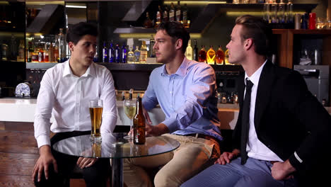 male friends enjoying a beer together