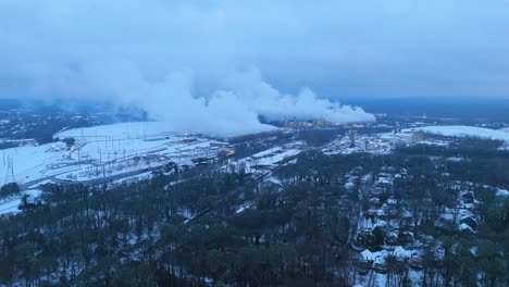 aerial shot pushing in on snow covered georgia power plant on the evening of january 10th 2025.