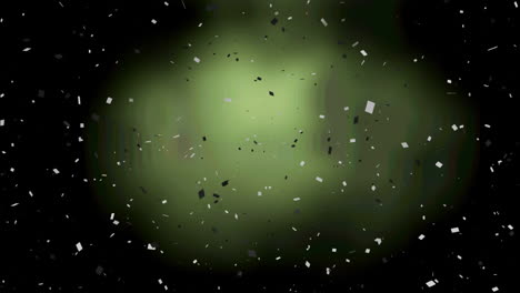 animation of black and white confetti over green background