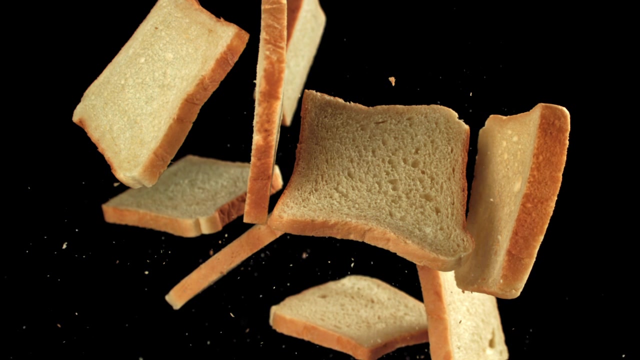 White Bread Slices Falling in Slow Motion with Crumbs