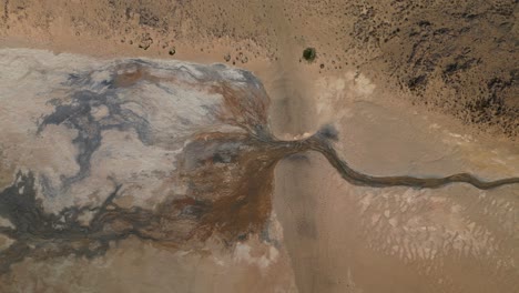 Geothermal-river-turns-into-an-abstract-puddle,-east-Iceland