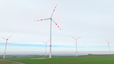 a view of wind power rotating over farmlands