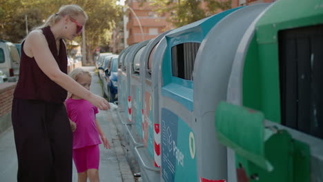 mother and daughter recycling paper