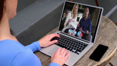 Caucasian-woman-using-laptop-on-video-call-with-colleagues-working-from-home