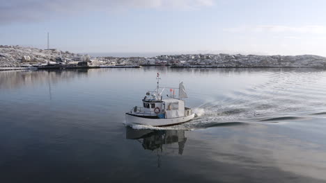 Drone-view-of-a-moving-fishing-boat-at-the-ocean-sea-with-ocean-sea-water-wave-reflections