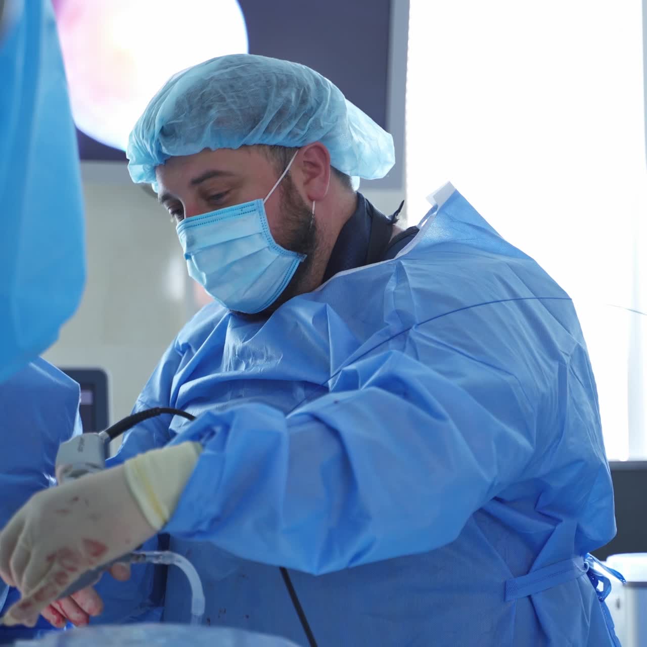 Surgeon working with surgical instruments. Process of gynecological surgery operation using laparoscopic equipment