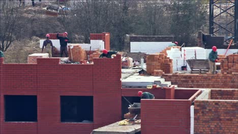close up of builders with a red helmets on a building under construction. time lapse