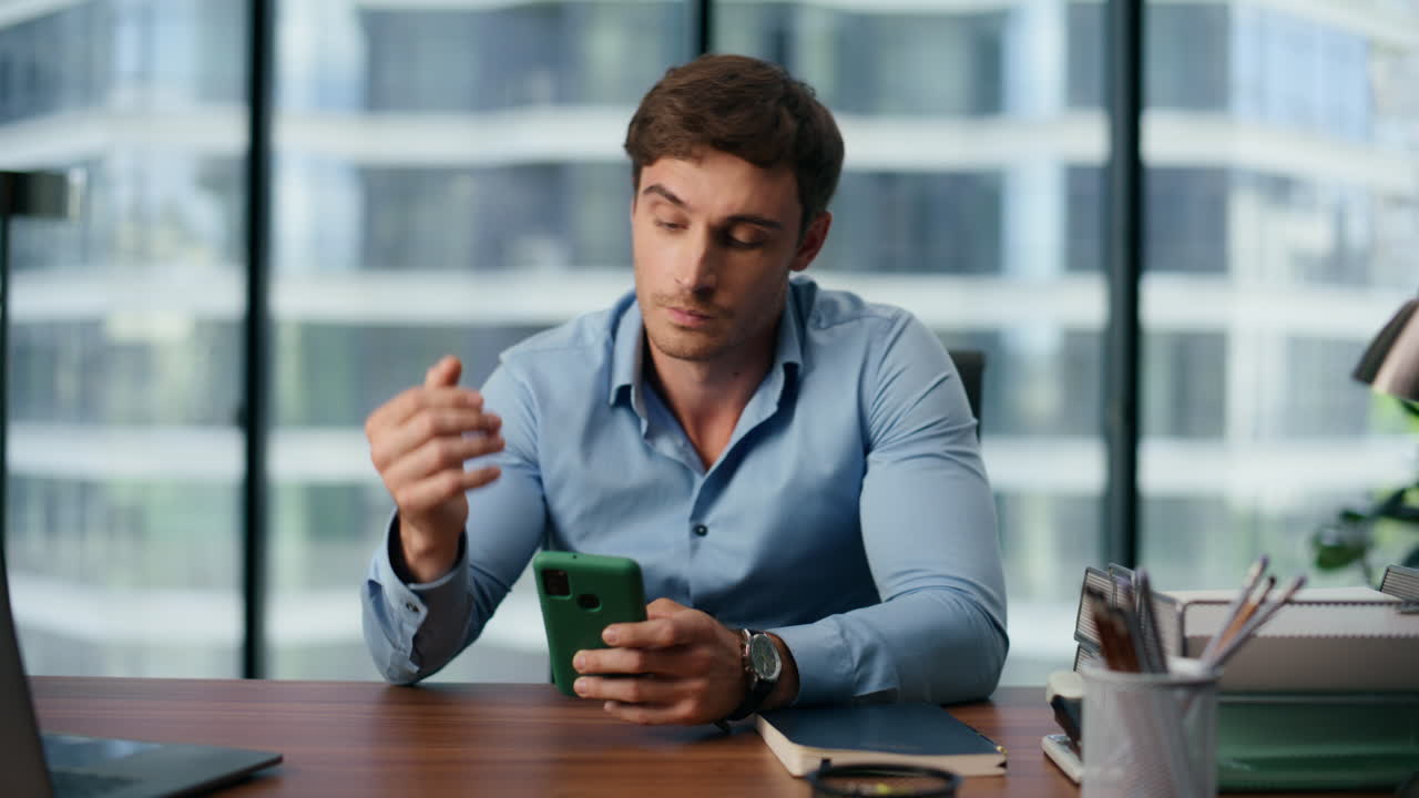 Premium stock video - Tired businessman watching mobile screen at ...
