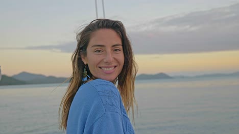 Female-Traveler-On-A-Sailboat-Smiles-At-Camera