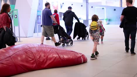 family exploring museum with children and strollers