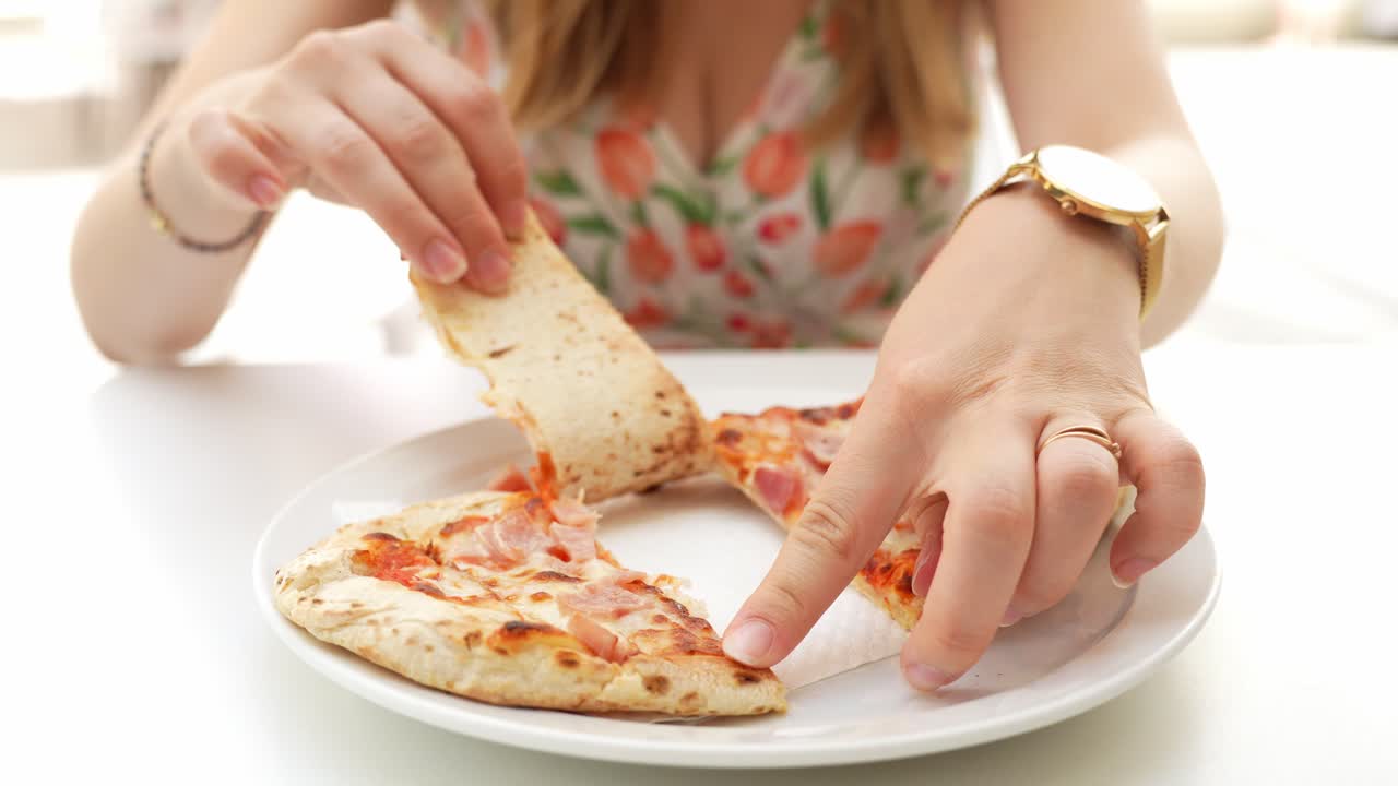 Woman's hands dividing delicious slices of pizza, Las Galletas, close up